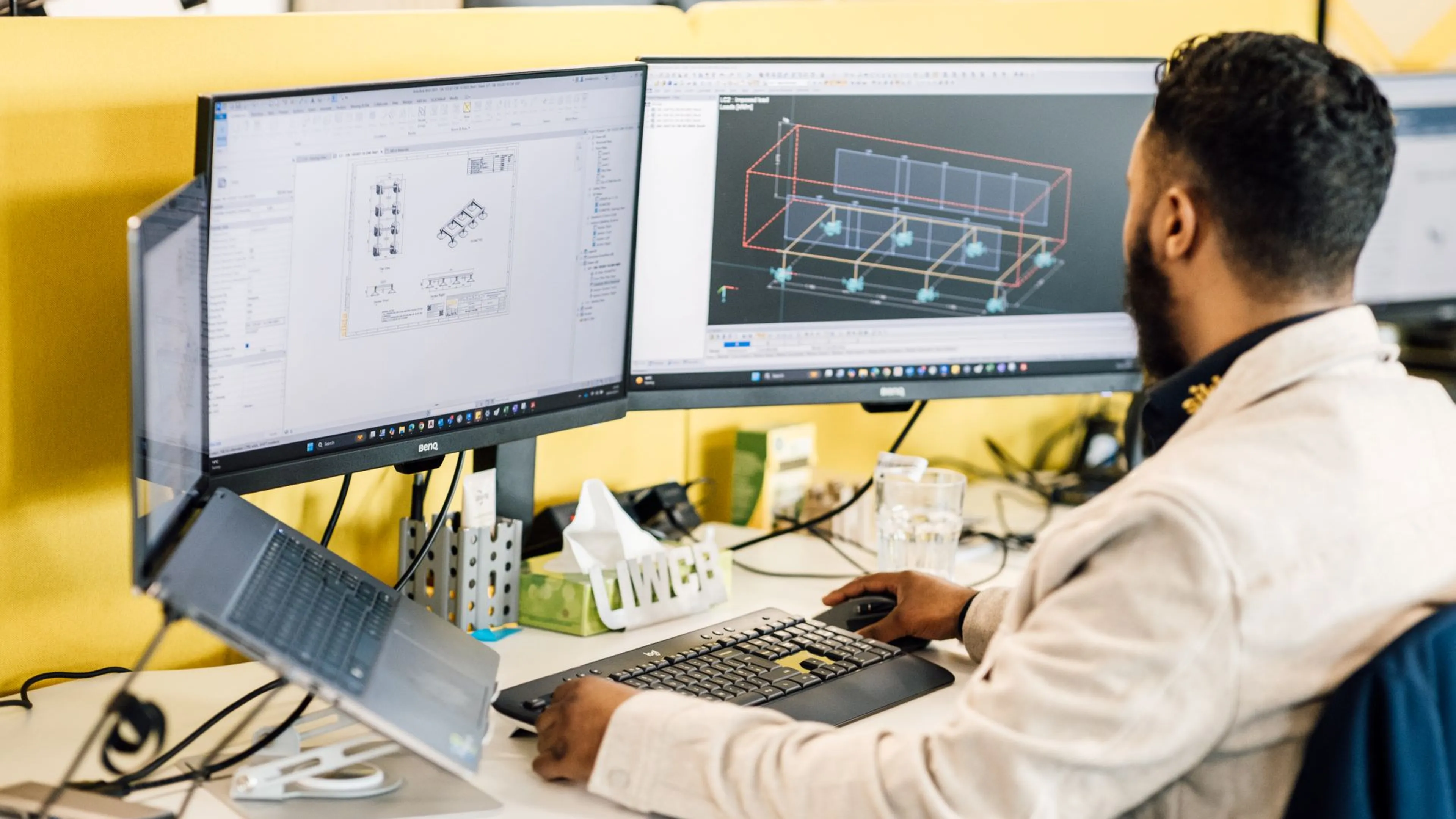 Sikla structural engineer using a computer at their desk to design a HVAC solution using BIM