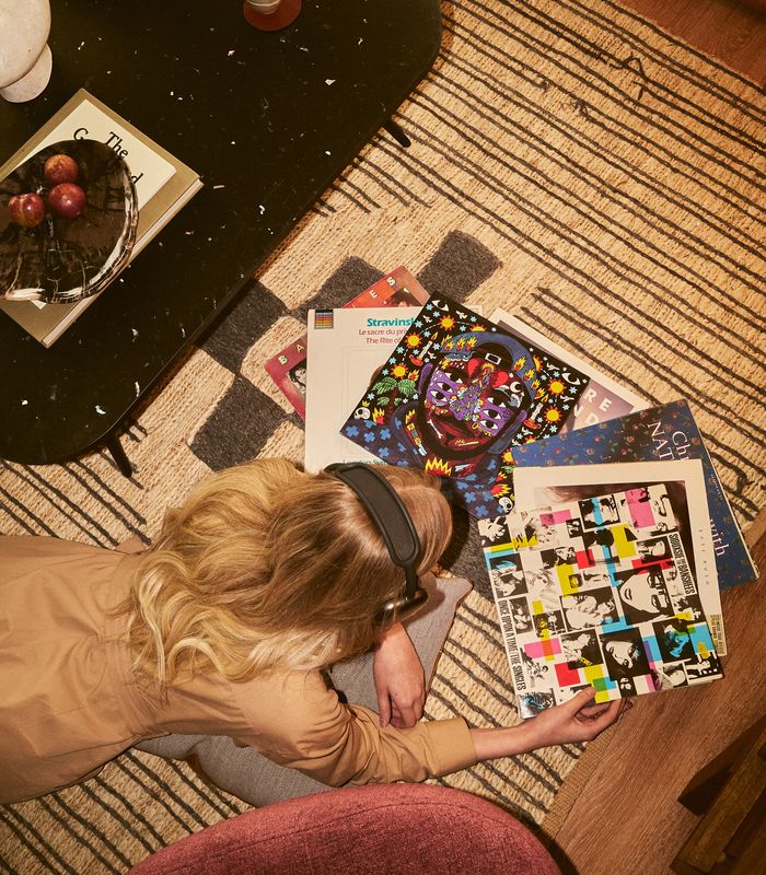 Woman laying on floor listening to records
