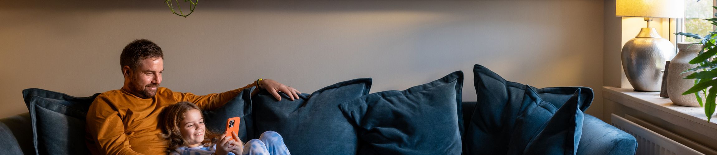 Dad and daughter on blue sofa