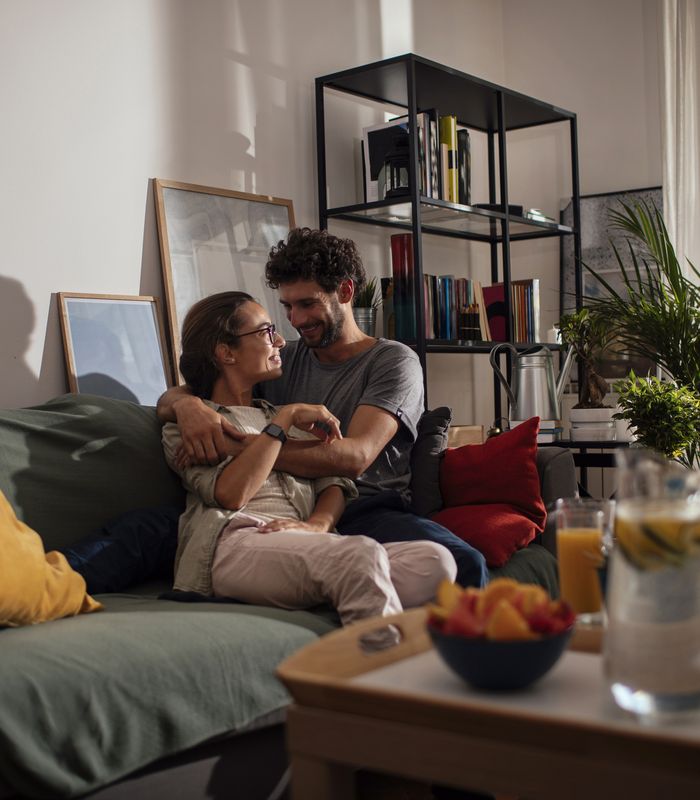 Couple snuggling on a sofa