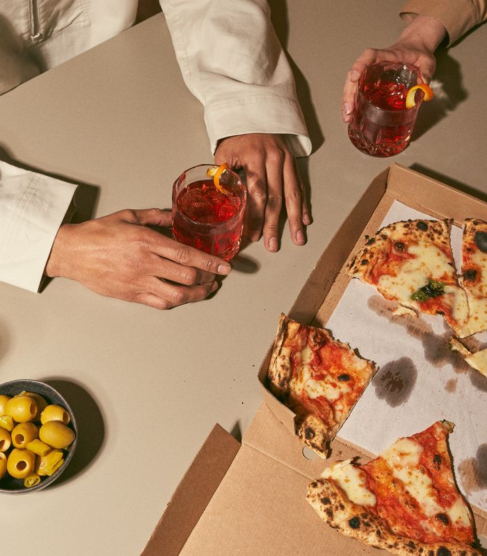 people eating pizza and olives with drinks