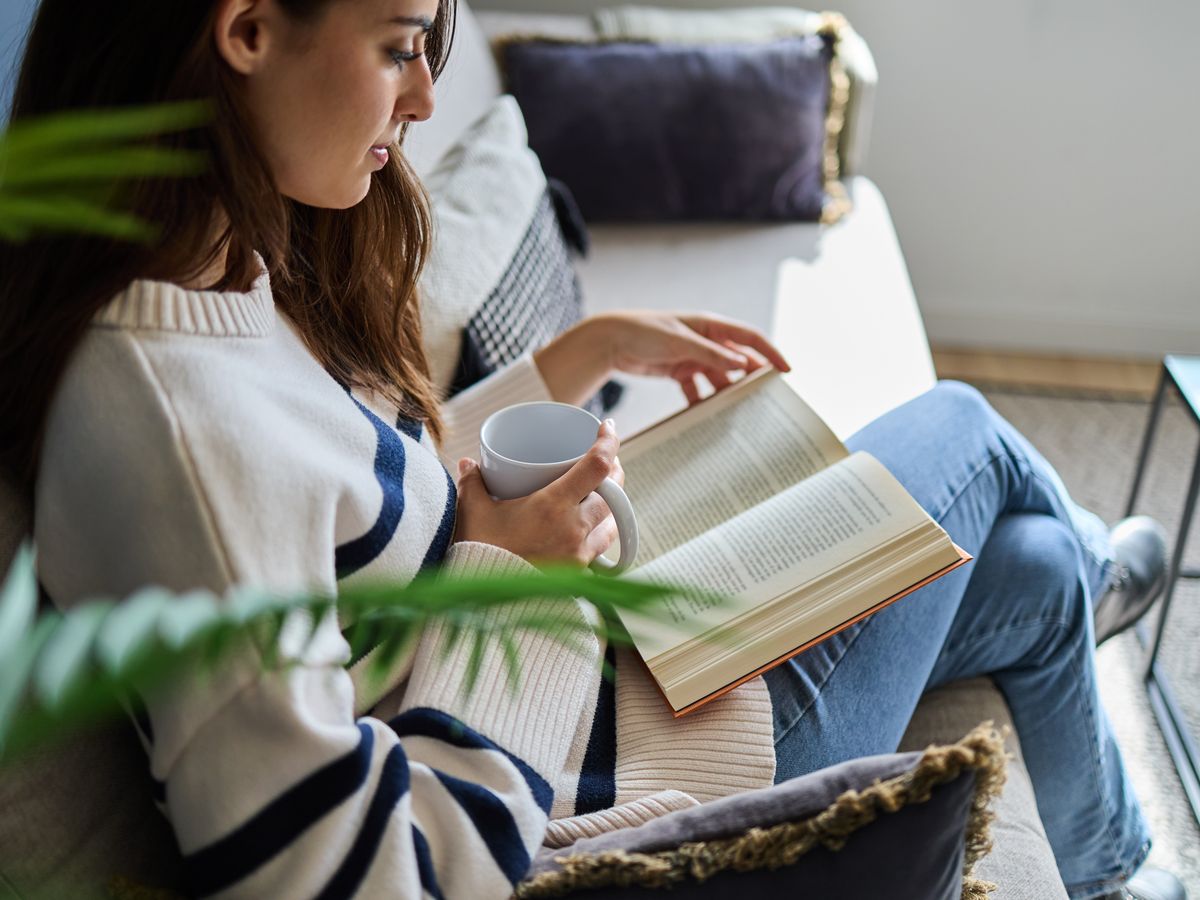 Woman reading sitting on sofa