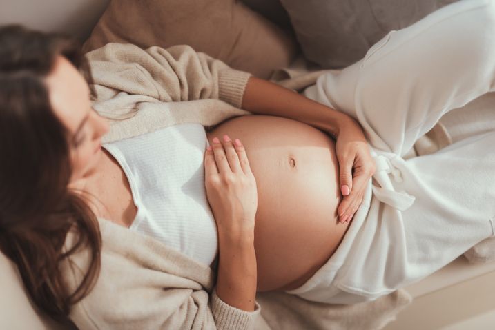 Frau hält sich den Schwangerschaftsbauch