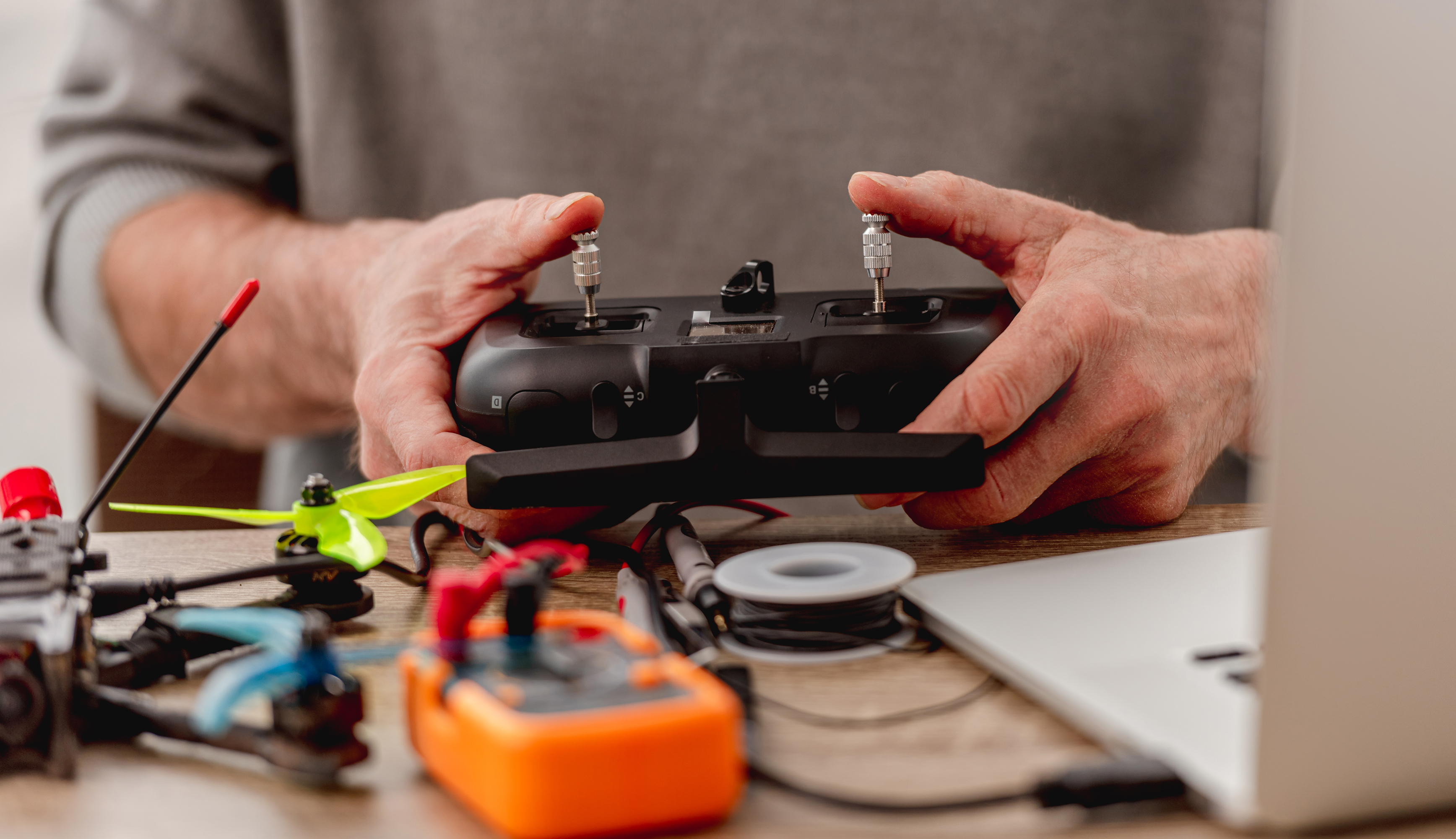 Engineer programming a drone flight controller on a test bench