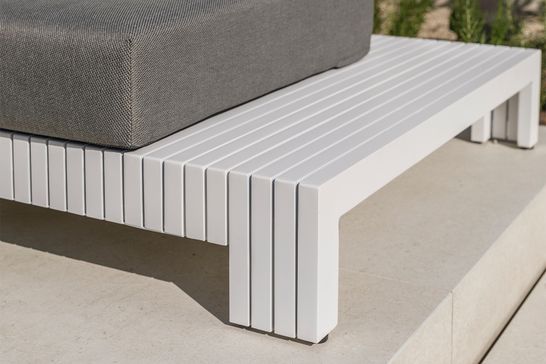 White aluminium lounge with gray outdoor cushions