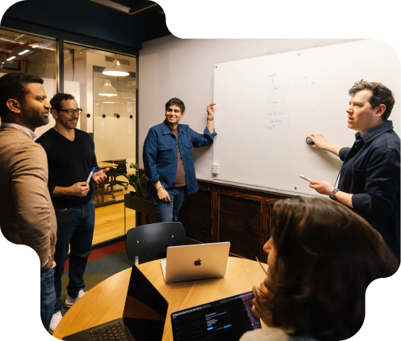 4 people having a meeting on an office room, talking about monetization strategies