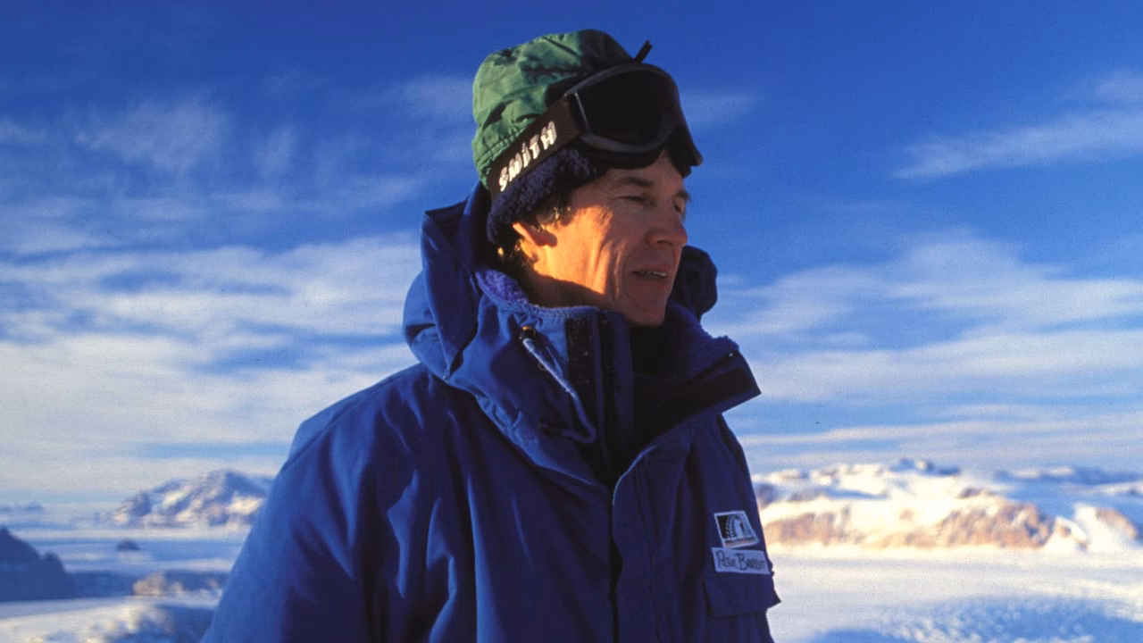 Peter Barrett on the ice with the Transantarctic Mountains in the 1990s Credit: Hannes Grobes. Creative Commons 2.5