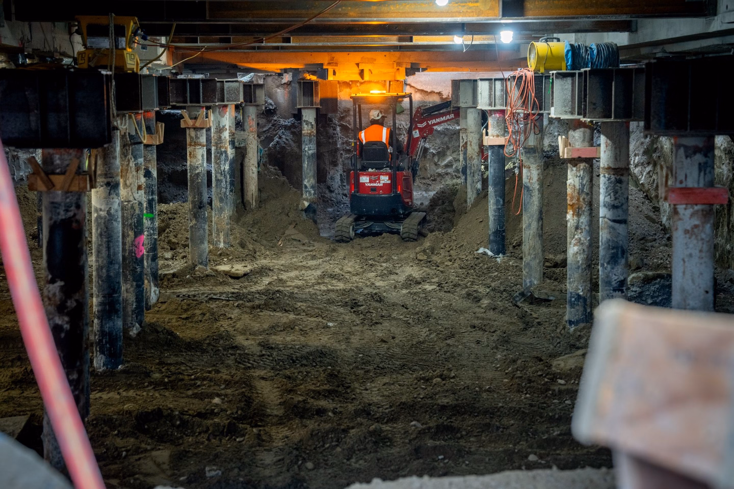 A mechanical digger excavates between the micropiles under the Robert McDougall Gallery.