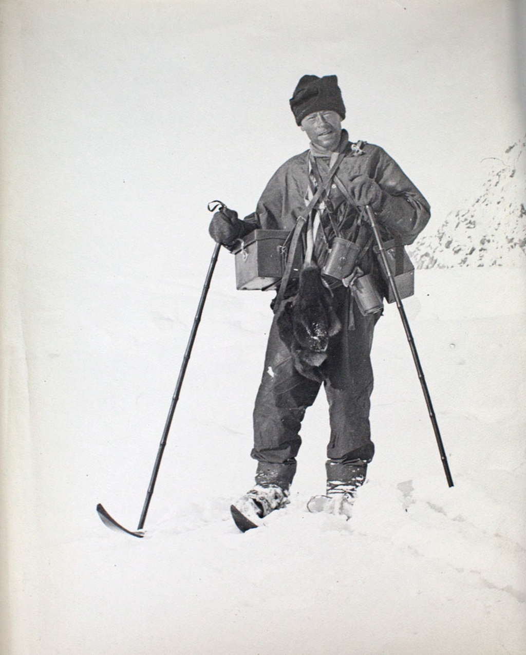 George Murray Levick on the ice with skis, poles and camera gear in about1912.