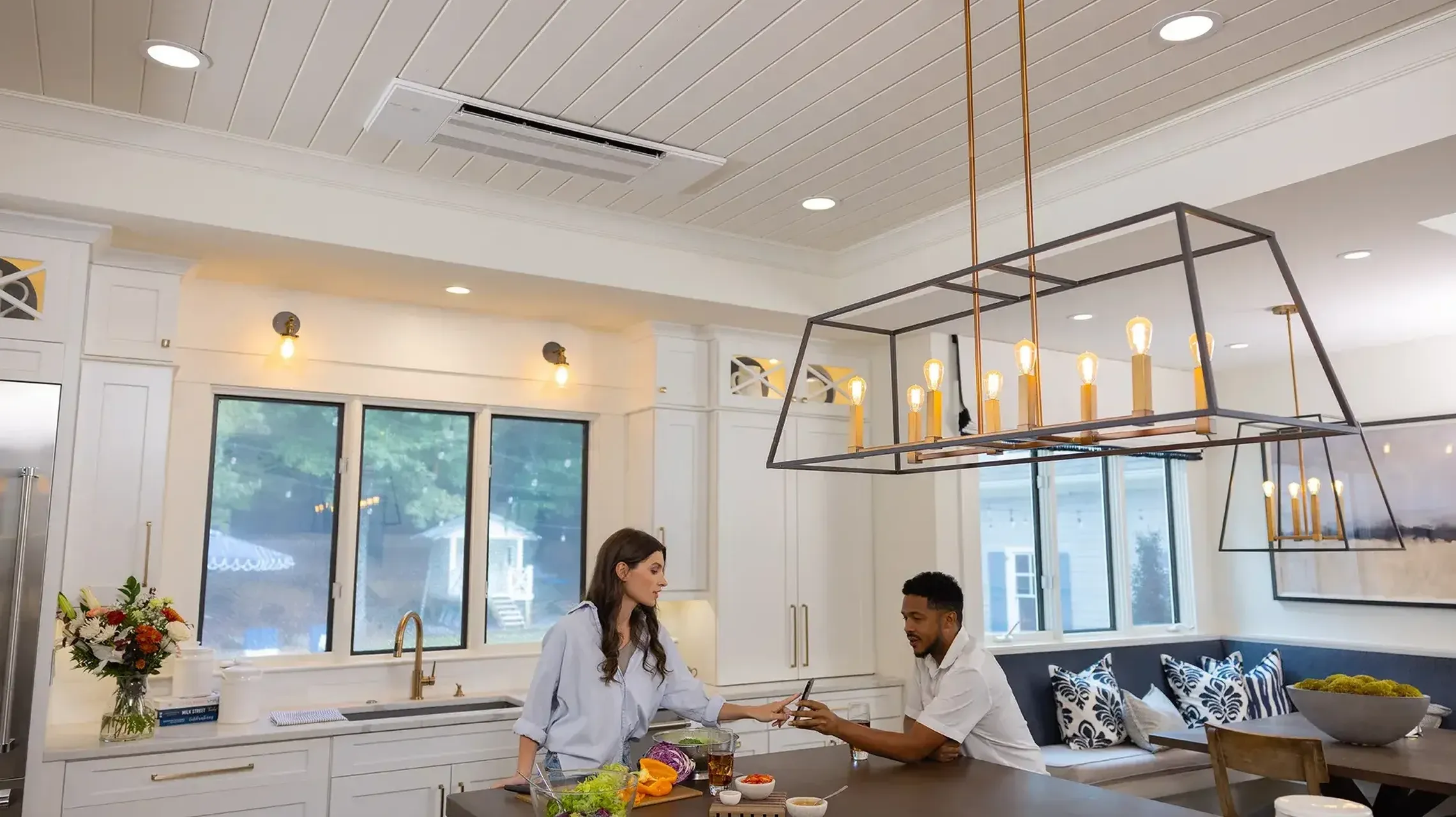 A kitchen with a mini split heat pump in the ceiling
