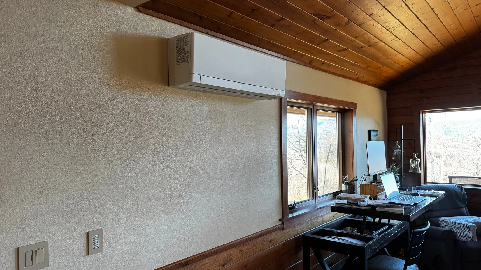 An air handler unit mounted on the wall of an office