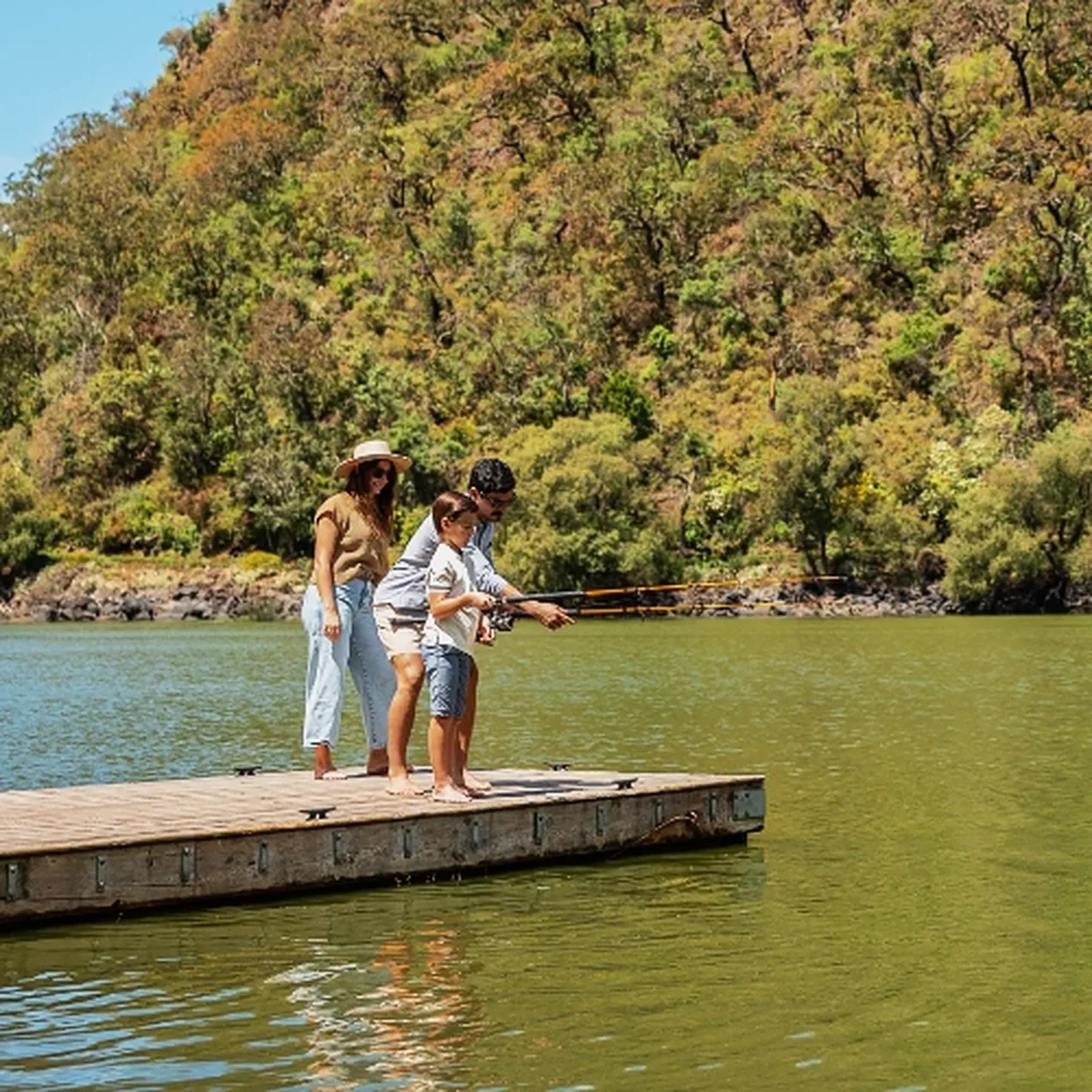 Family fishing on a dock at Juanacatlán Lake