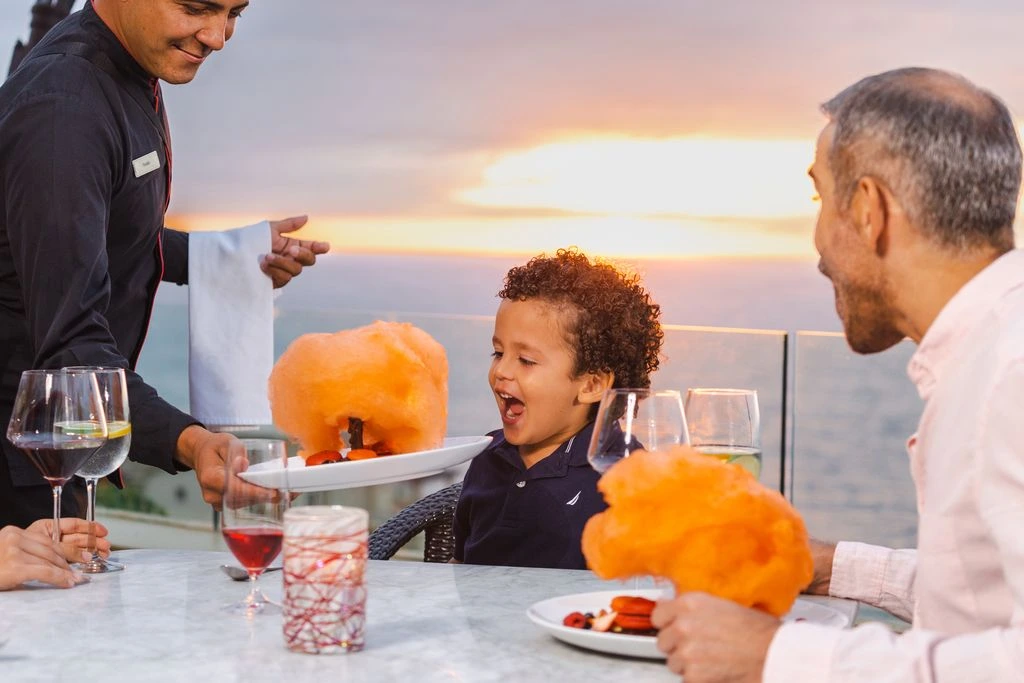 kid got amazed by the dish at a oceanfront restaurant