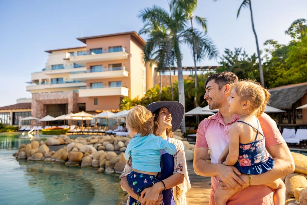 family of four spending time in the pool
