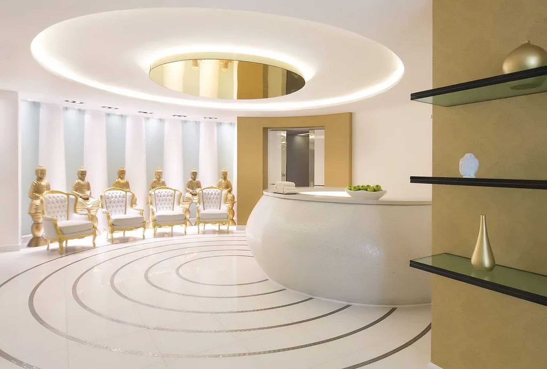 Elegant, modern hotel lobby with circular white reception, golden accents, sophisticated seating, and soft lighting.