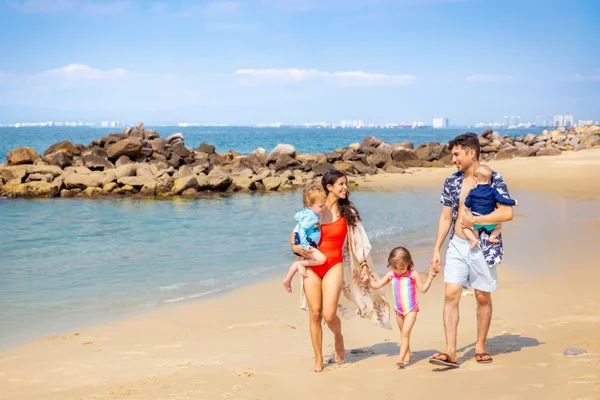 Family walking on the beach at Garza Blanca Puerto Vallarta