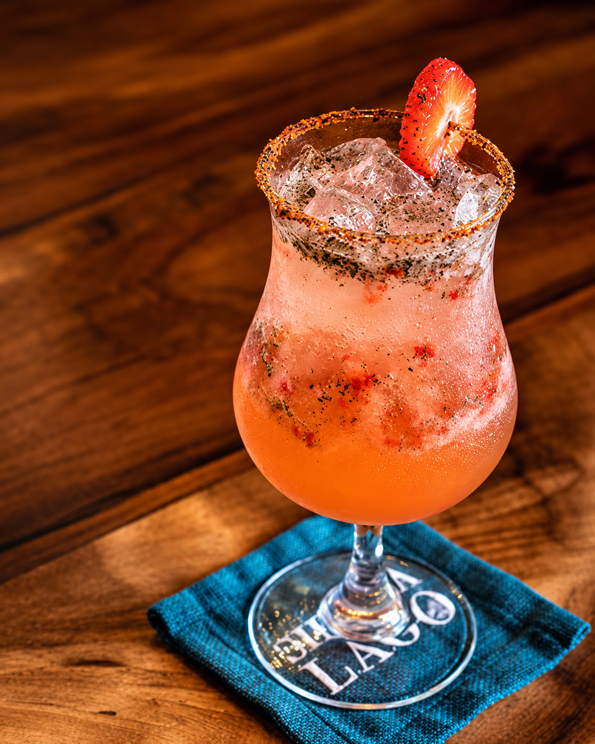 Chili-Rimmed Strawberry Cocktail on Teal Napkin Sierra Lago