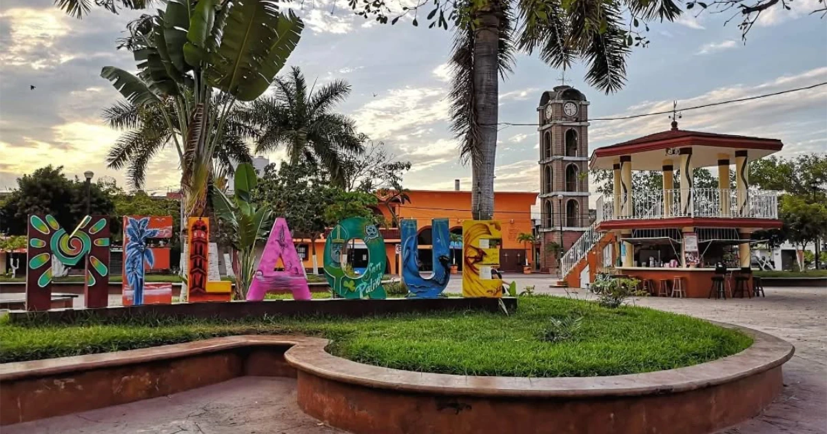 Melaque town square with colorful letters, palm trees and bandstand