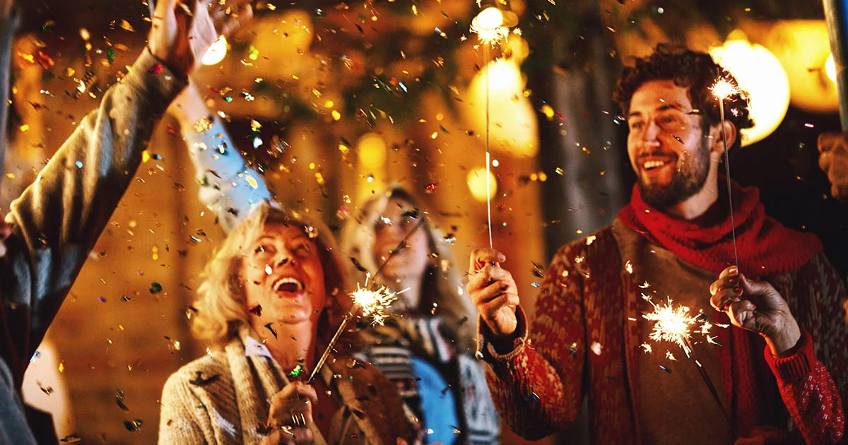 Family raising a toast and celebrating at midnight on New Year's Eve