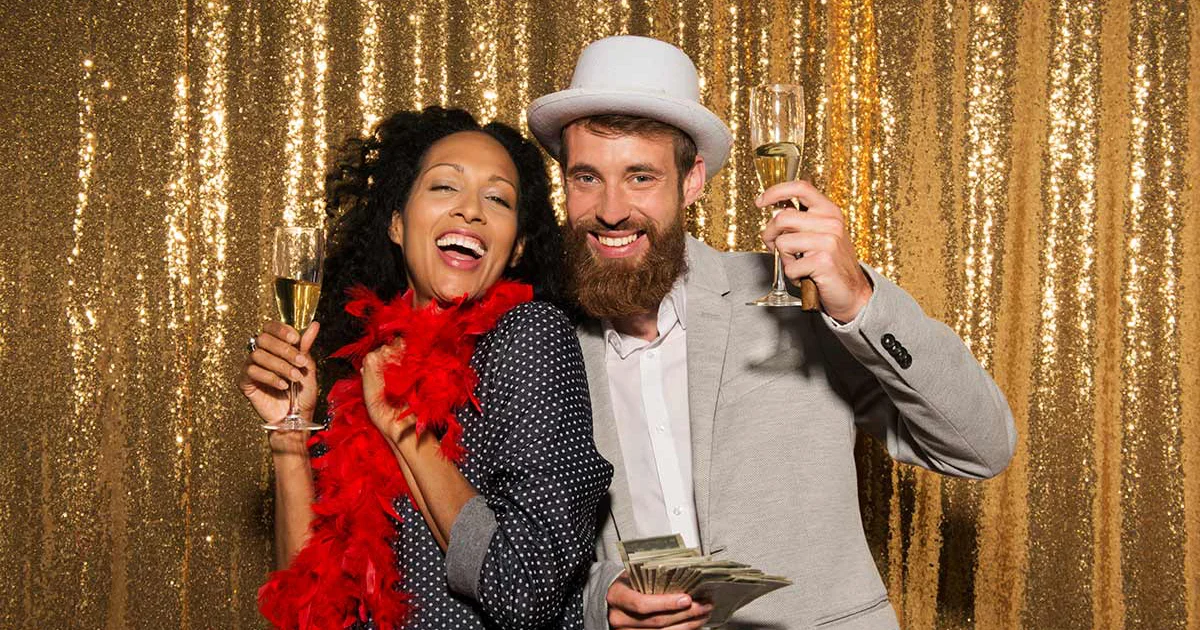Family posing with festive props at a New Year's photo booth