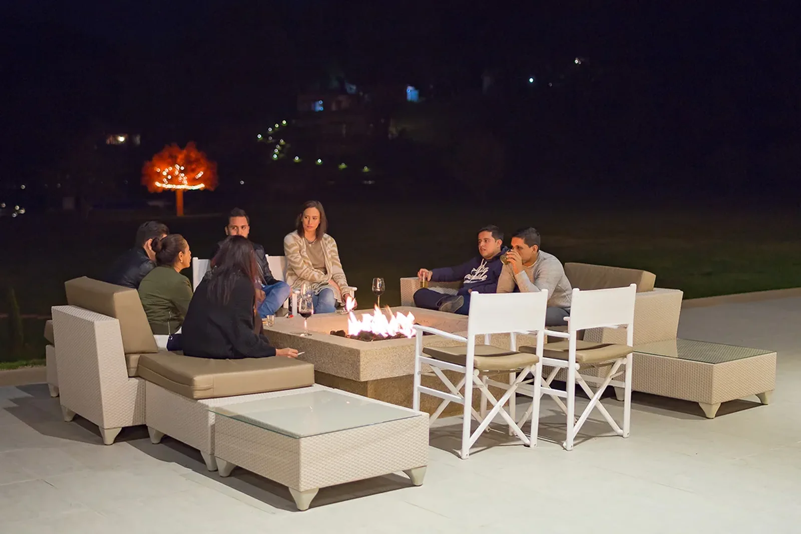 Evening bonfire with friends on a terrace