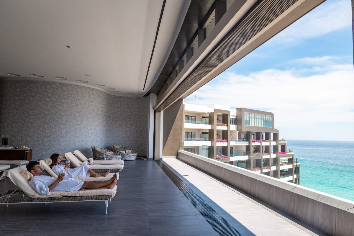couple in robes on spa imagine cabo chaises