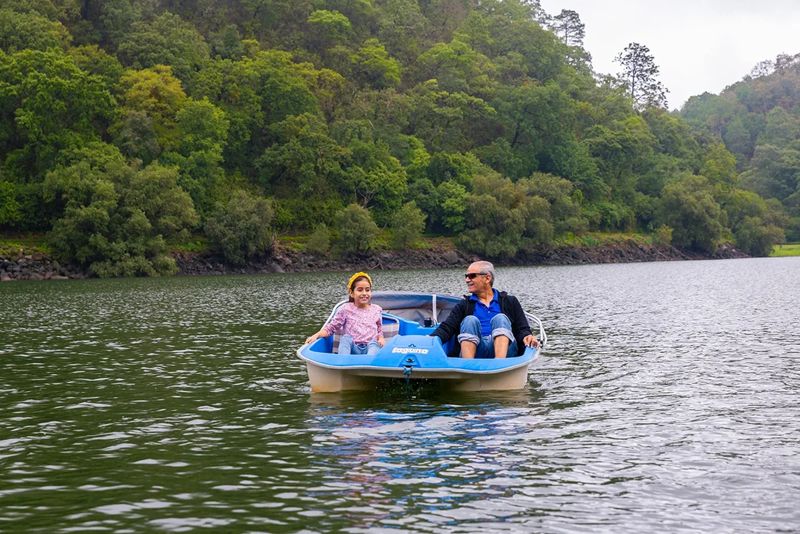 Family on a pedal boat on the lake