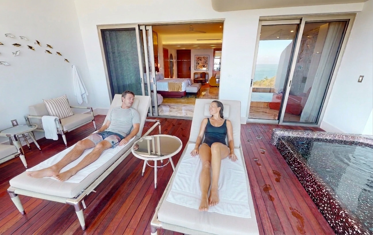 couple resting in pool chairs
