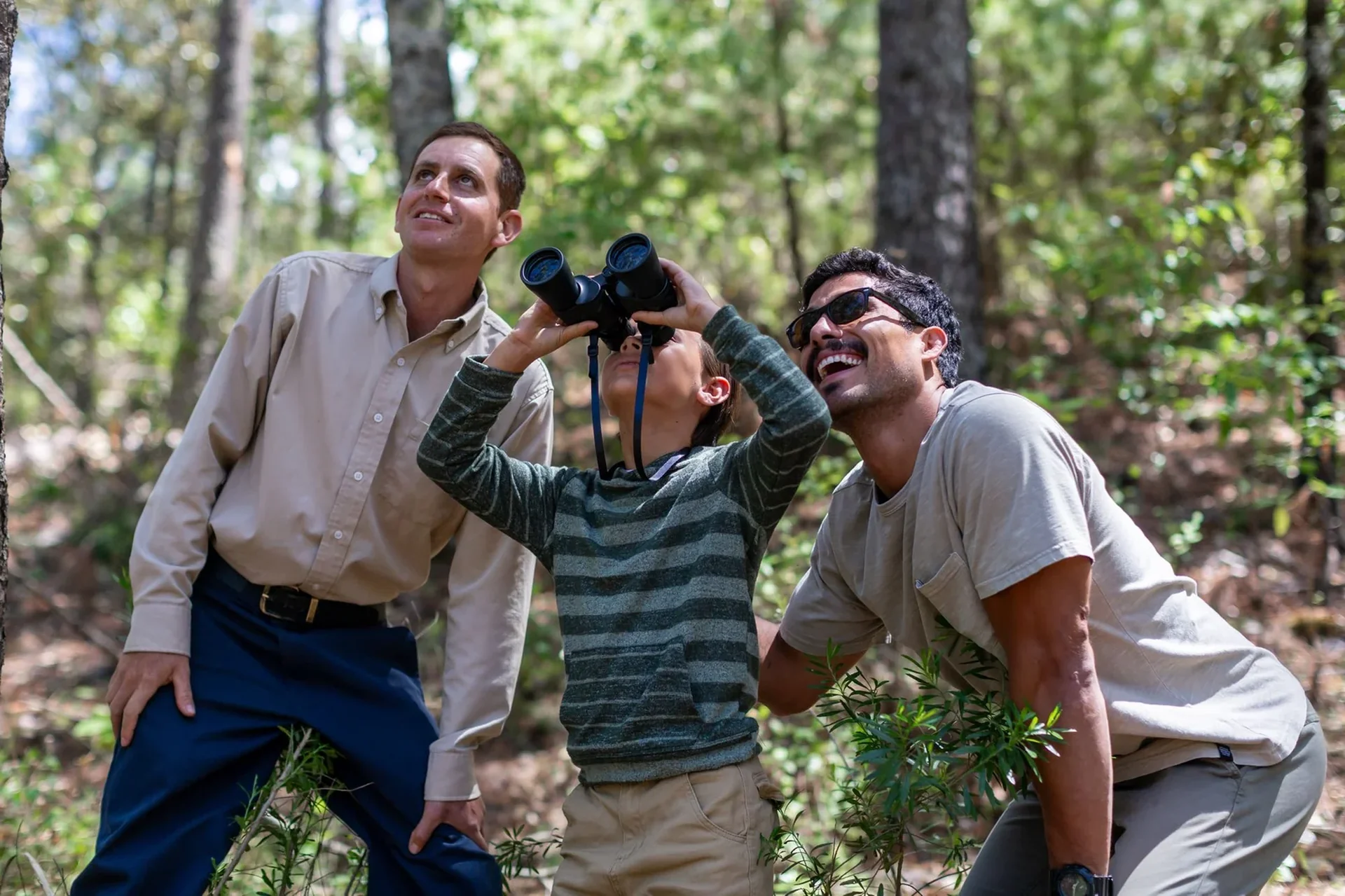 Students exploring the forest with binoculars at Sierra Lago