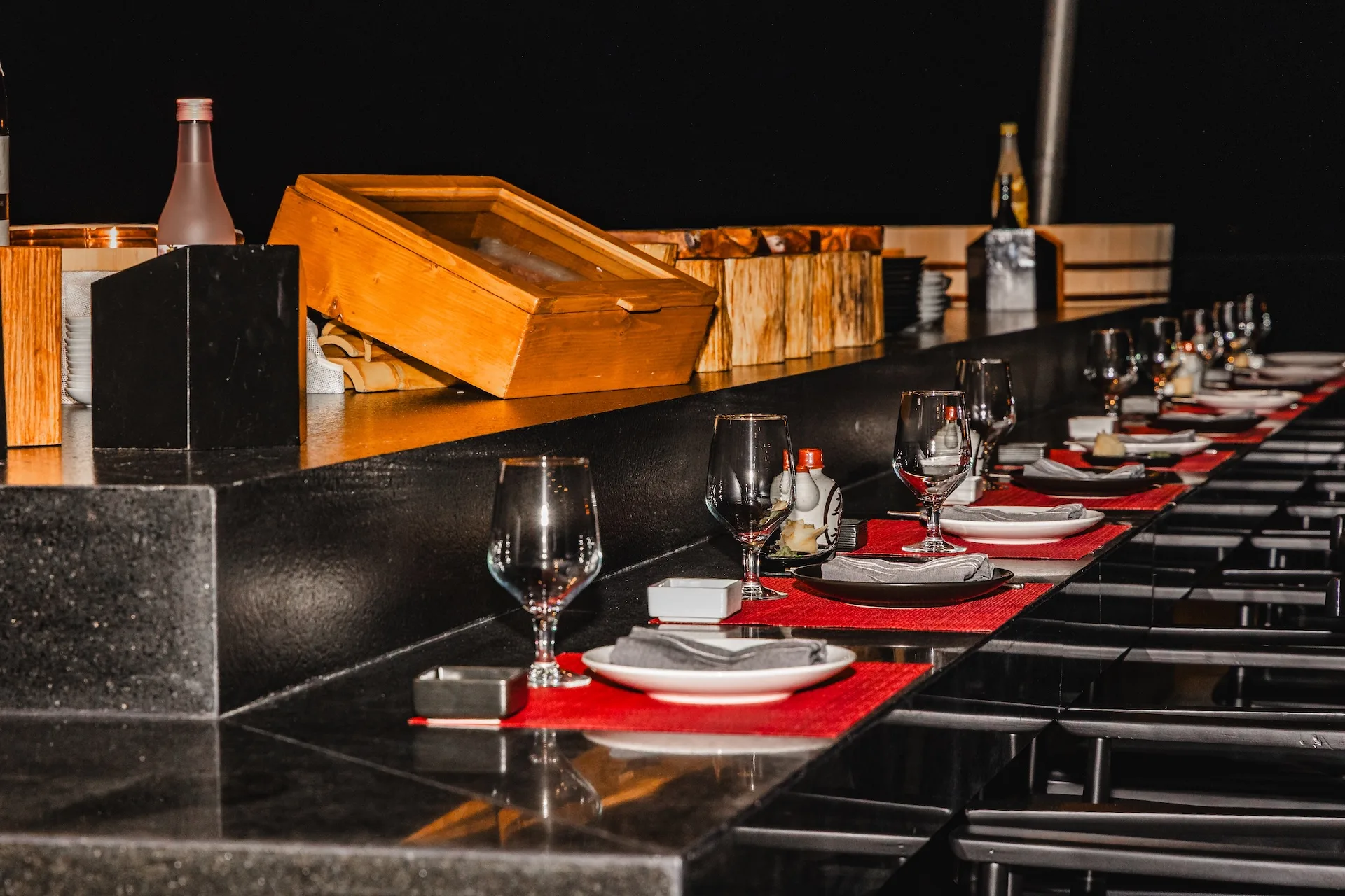 Omakase counter illuminated for evening service