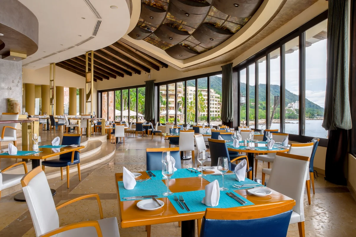 Blanca Blue restaurant dining room with ocean and hillside views at Garza Blanca Puerto Vallarta