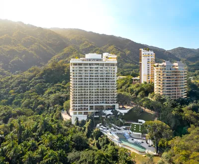 Aerial panoramic view of Garza Blanca Sanctuary oceanfront resort between the Pacific Ocean and the Sierra Madre mountains in Puerto Vallarta.