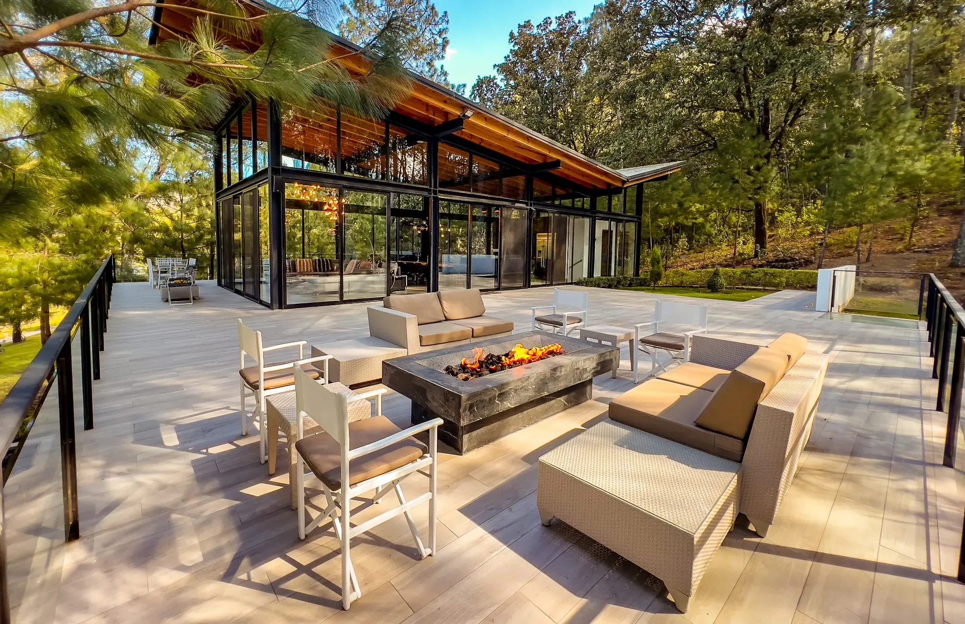 Casa Lago terrace with fire pit surrounded by forest at Sierra Lago