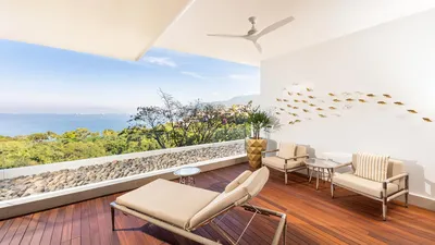 Junior Suite at Garza Blanca Sanctuary with a king bed, ocean views and a private terrace in Puerto Vallarta.