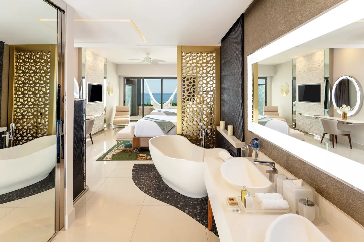 Junior Suite bathroom with freestanding tub open to the bedroom at Garza Blanca Los Cabos