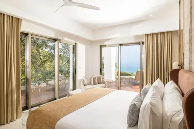 Corner Suite at Garza Blanca Sanctuary with panoramic ocean views, floor-to-ceiling windows and a spacious terrace in Puerto Vallarta.
