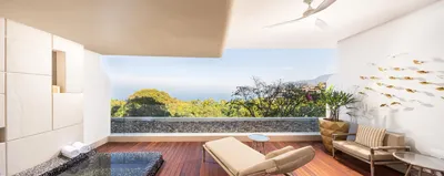 Junior Suite at Garza Blanca Sanctuary with a king bed, ocean views and a private terrace in Puerto Vallarta.