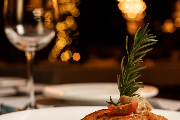 Sierra Lago Resort & Spa - Vertical view of grilled salmon with vegetables and wine at night