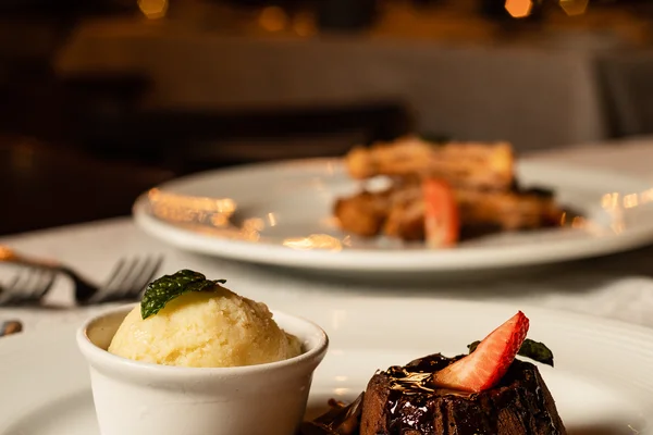 Sierra Lago Resort & Spa - Vertical view of a chocolate cake with ice cream and strawberries at dinner