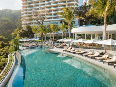 River-side pool at Garza Blanca Sanctuary surrounded by tropical greenery and lounge areas under the Puerto Vallarta sky.