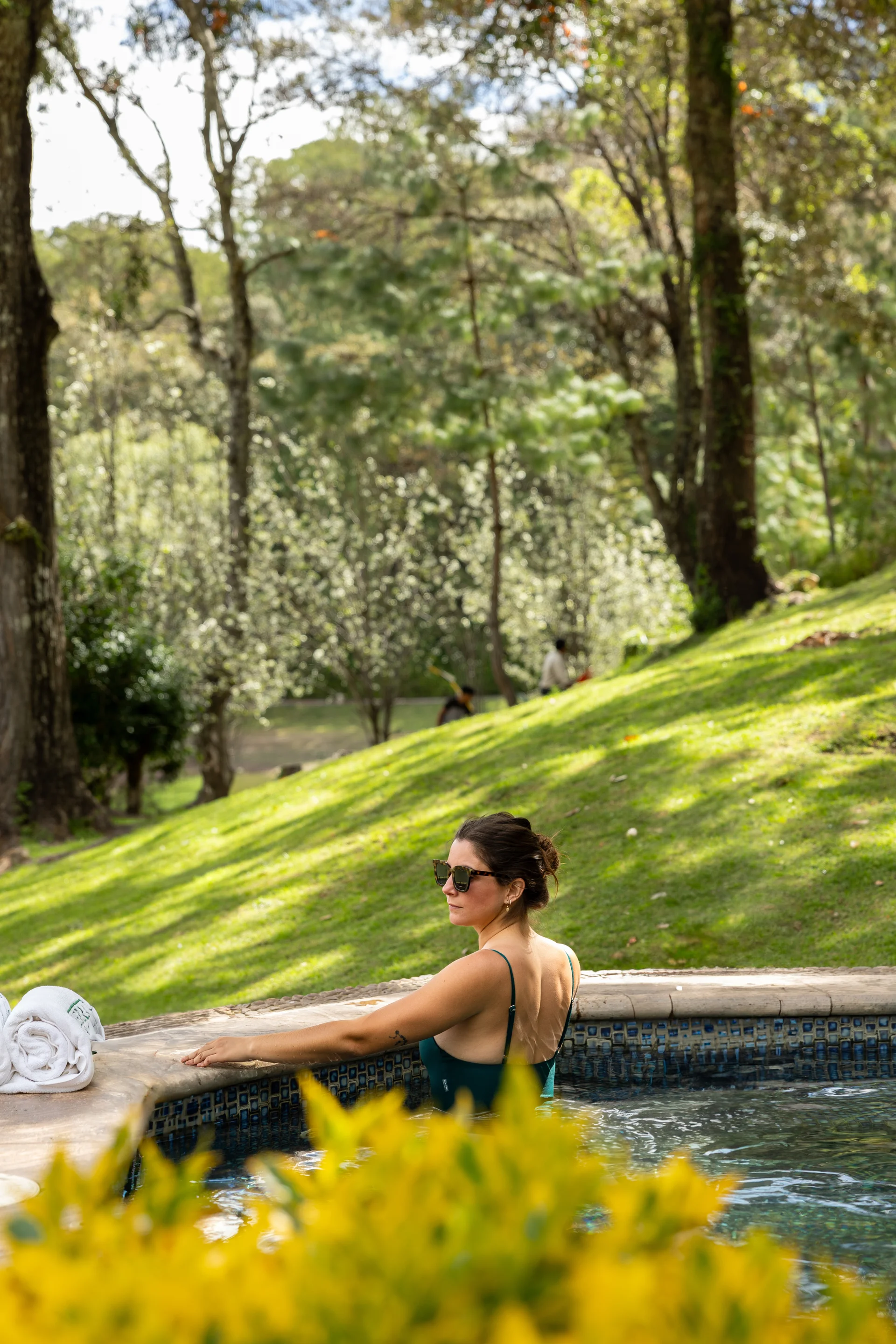 Sierra Lago Resort & Spa - Woman relaxing in an outdoor jacuzzi surrounded by trees and gardens