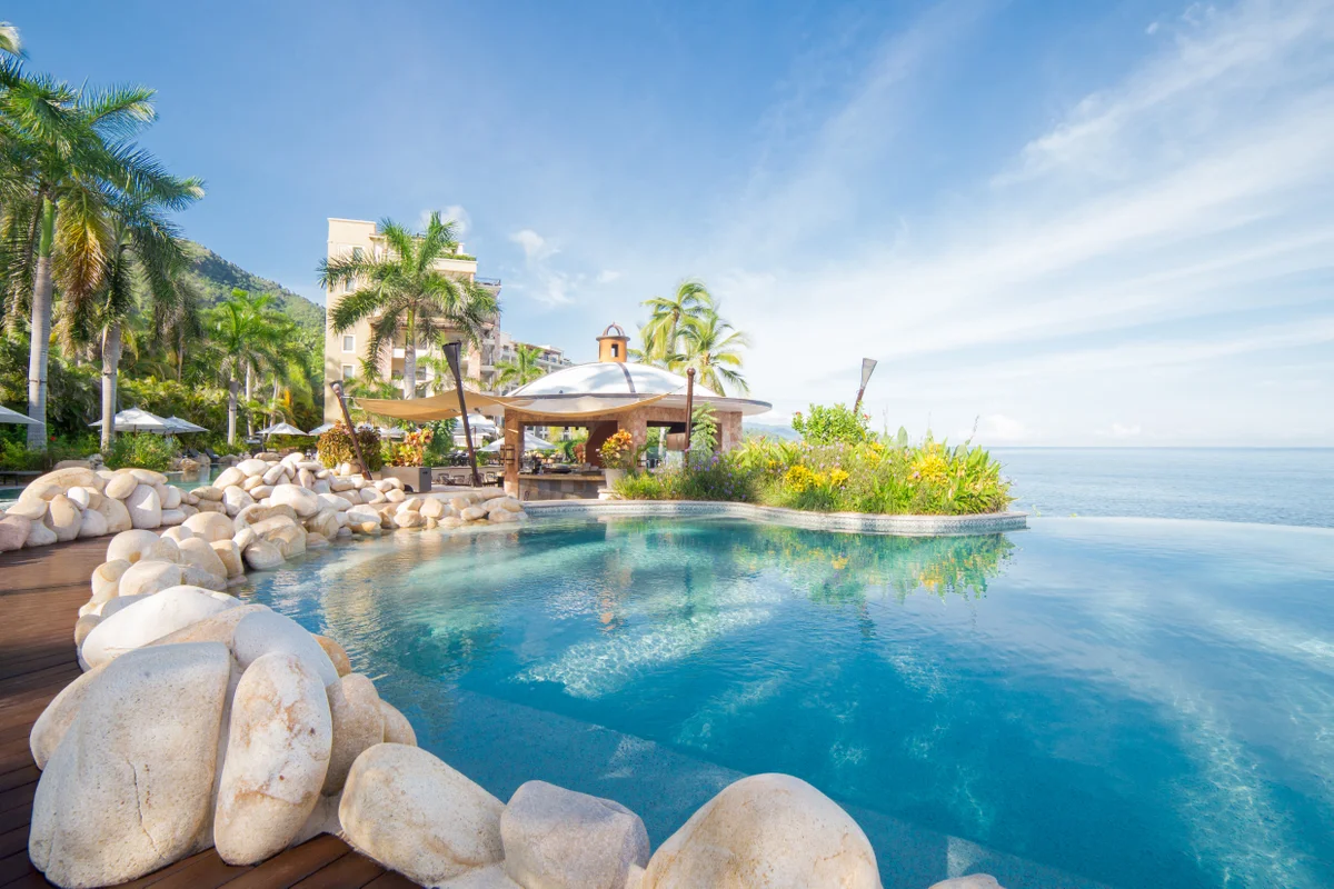 Pool with a gazebo, white boulders, and ocean views at Garza Blanca Puerto Vallarta