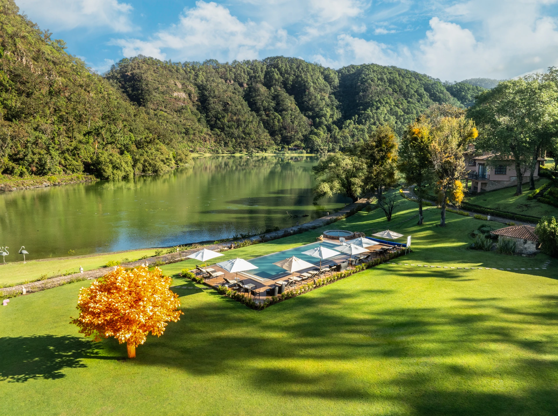 Sierra Lago Resort & Spa - Aerial view of the pool area with umbrellas beside the lake and mountains