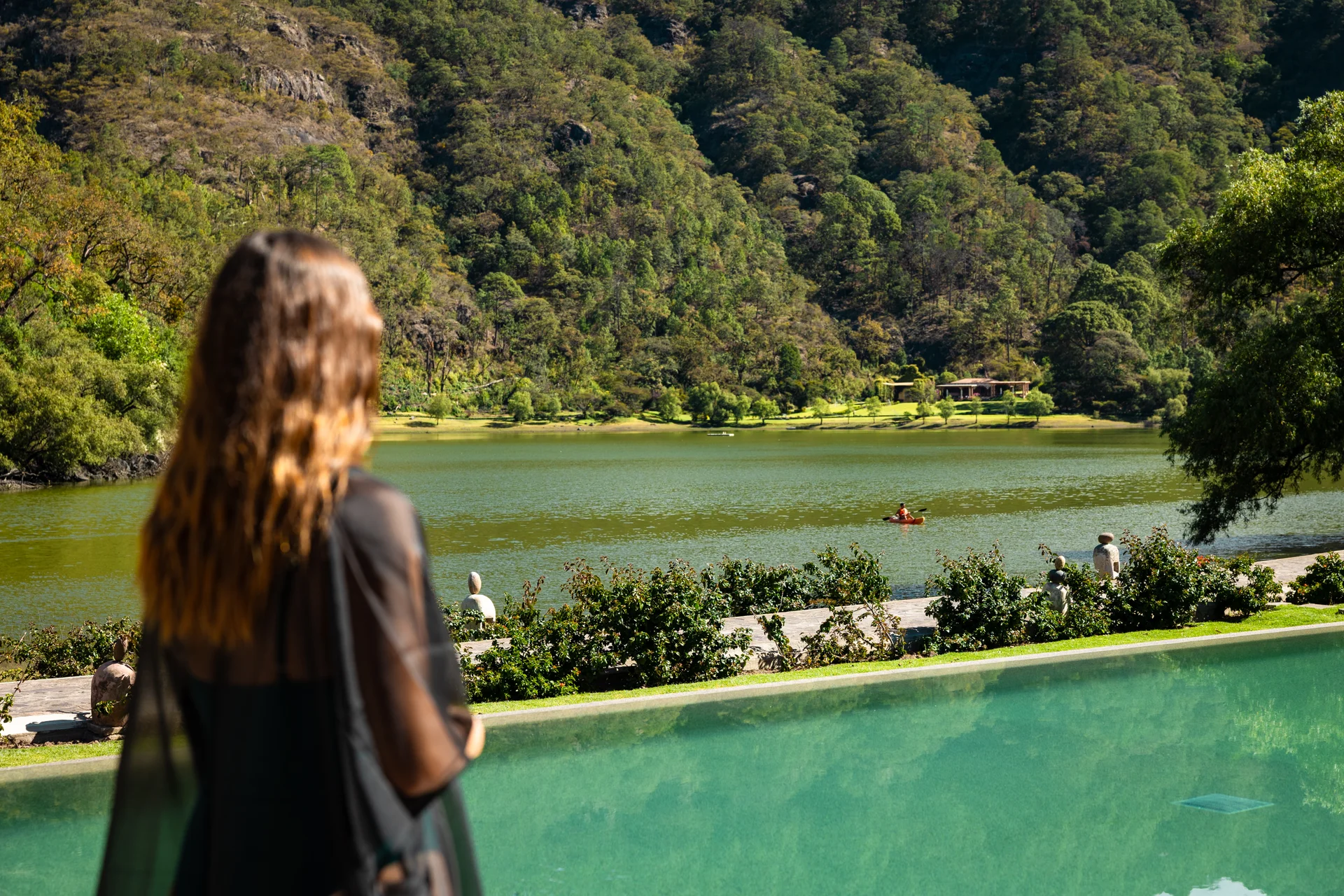 Sierra Lago Resort & Spa - Woman looking at the lake and mountains from the edge of the pool