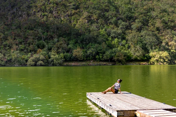Sierra Lago Resort & Spa - Woman relaxing on a wooden dock over the calm green lake