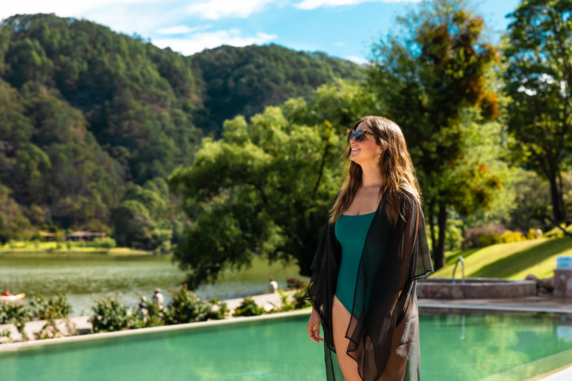 Sierra Lago Resort & Spa - Woman standing by the pool with the lake and mountains behind her