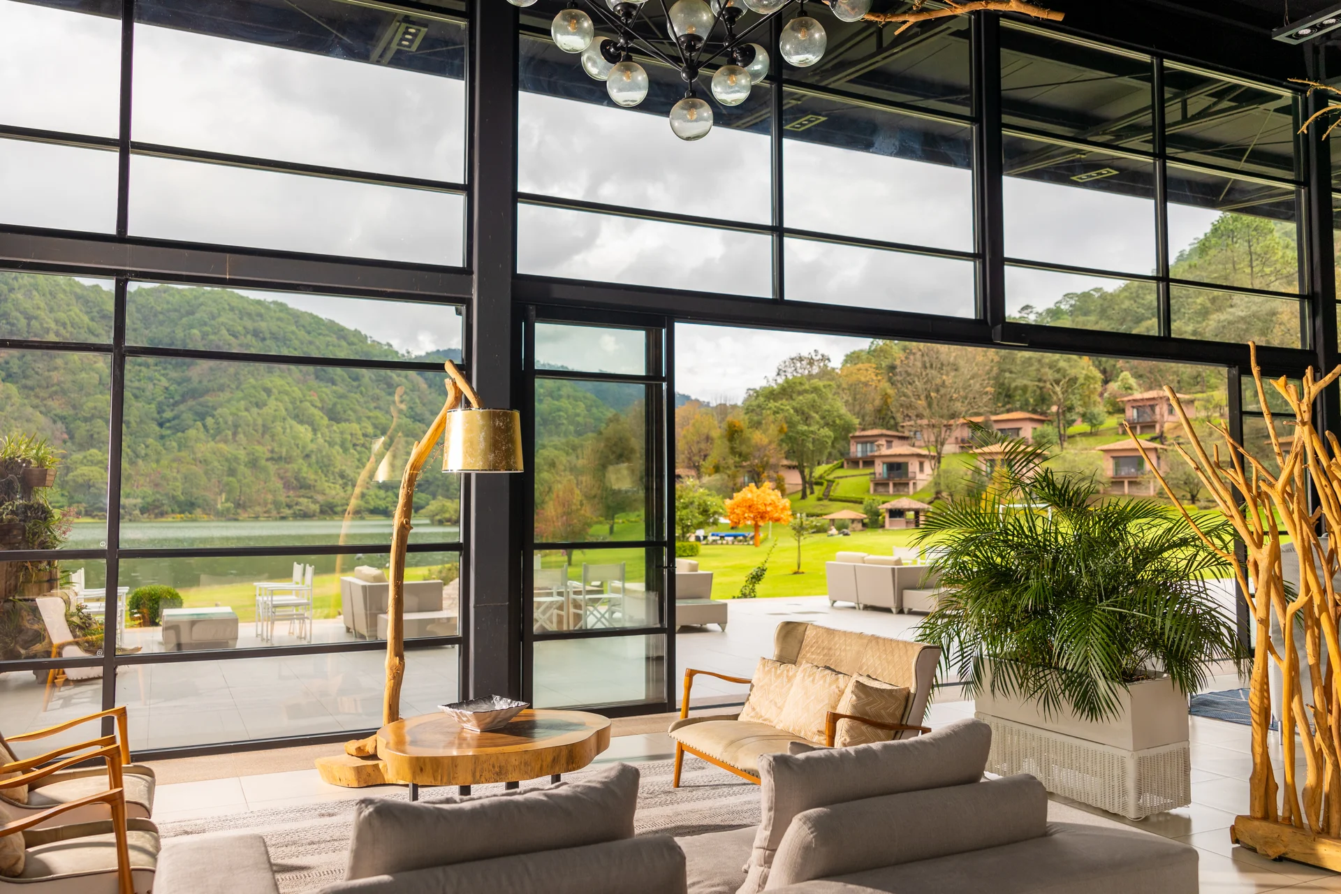 Sierra Lago Resort & Spa - Spacious lounge with sofas, plants and windows opening to the lake and gardens