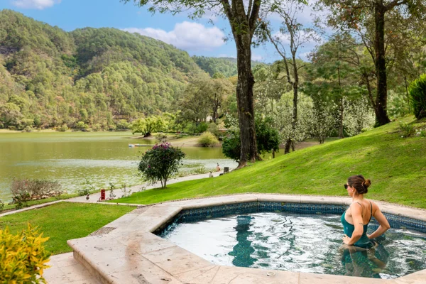 Sierra Lago Resort & Spa - Guest relaxing in an outdoor jacuzzi on the lawn by the lake