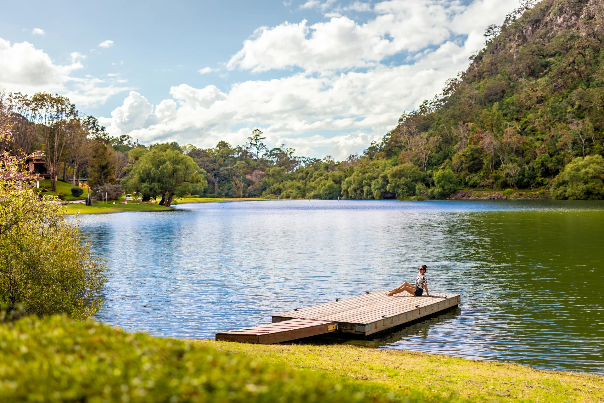 Sierra Lago Resort & Spa - Guest relaxing on a wooden dock on the lake surrounded by forested mountains