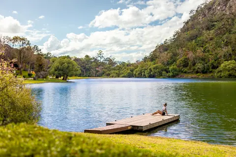 Sierra Lago Resort & Spa - Guest relaxing on a wooden dock on the lake surrounded by forested mountains
